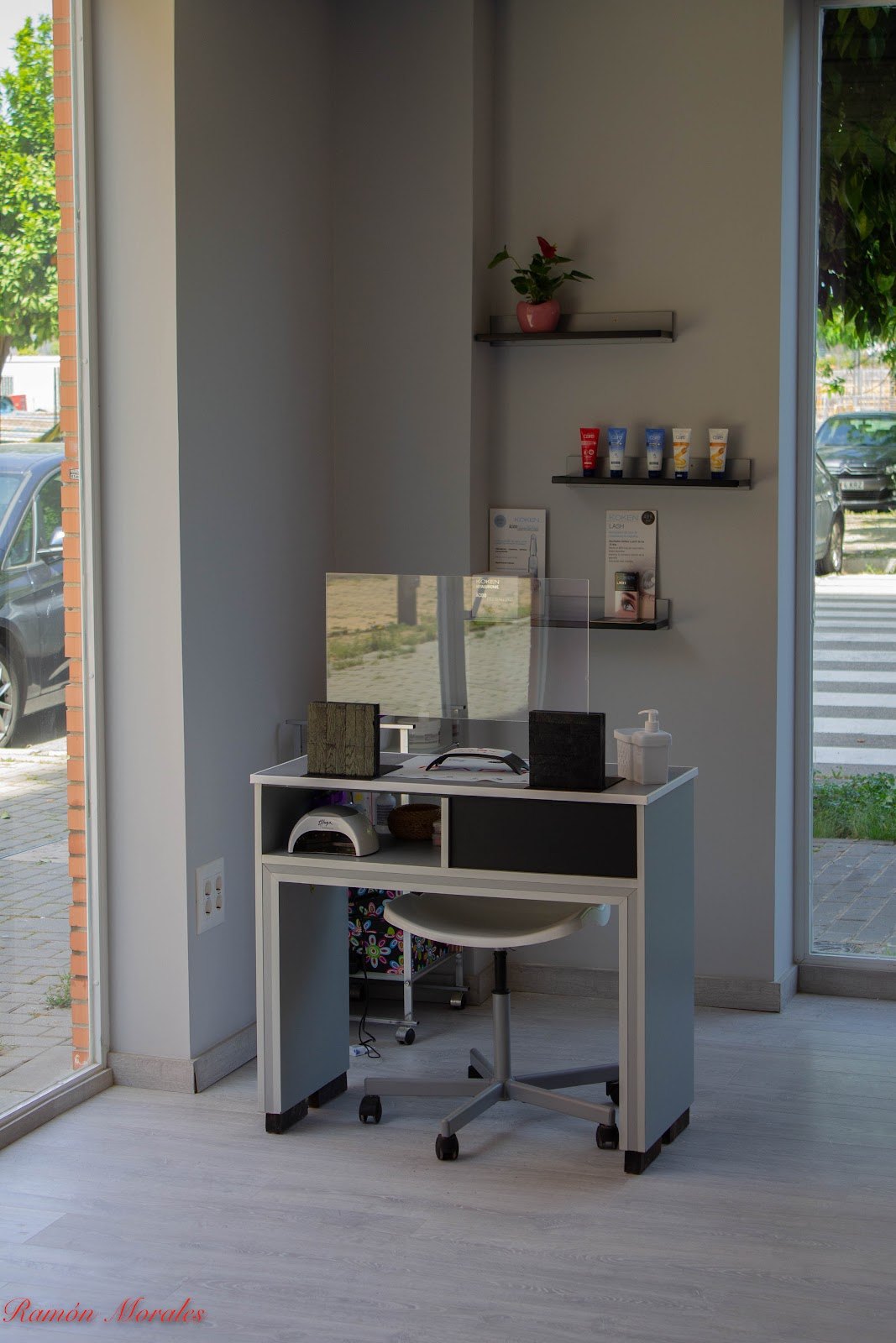 Mesa de manicura con lámpara junto al escaparate